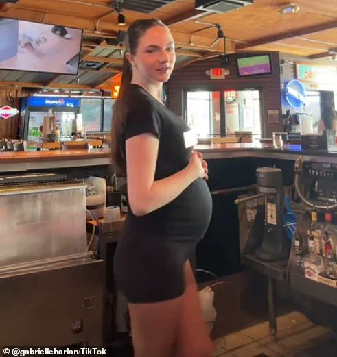 Pregnant Hooters waitress shows off her growing baby bump in iconic maternity uniform